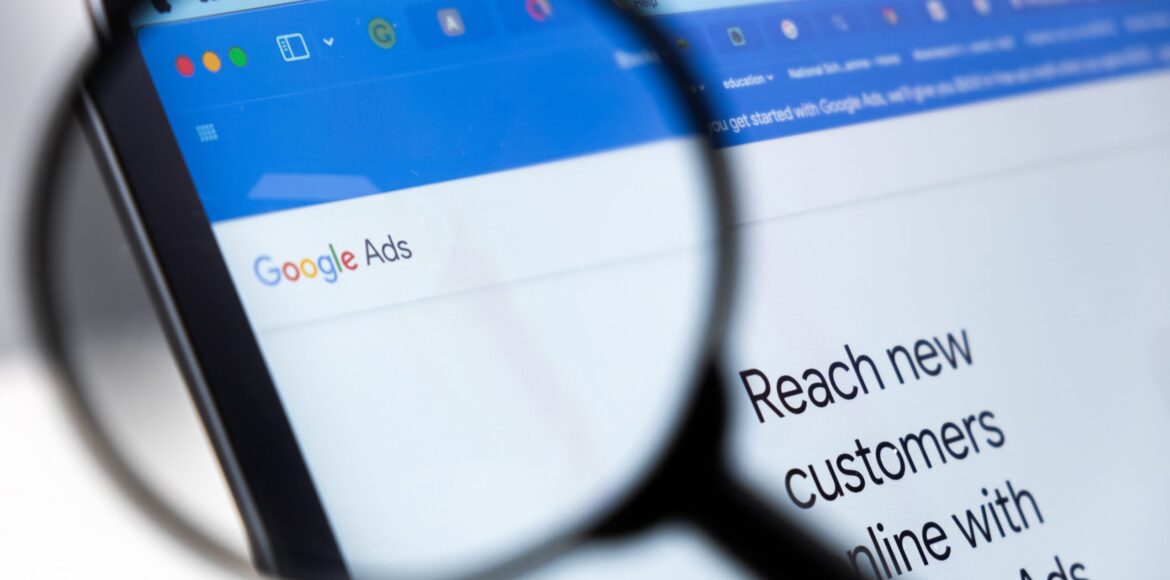 Google,Ads,Logo,Enlarged,Through,A,Magnifying,Glass,On,A