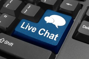 Close-up of a keyboard with a blue key labelled 'Live Chat' symbolising customer support in live chat e-commerce