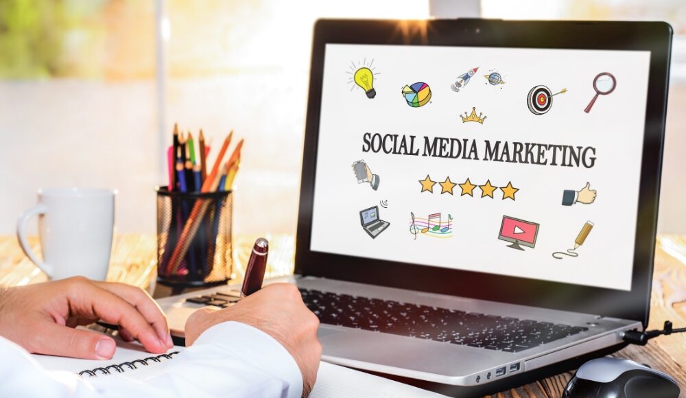 A person working on a desk with a laptop, illustrating the concept of developing an engagement marketing strategy for social media.