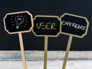 Signs displaying lightbulb, 'User', and 'Experience' concepts, focusing on how to design a business website.