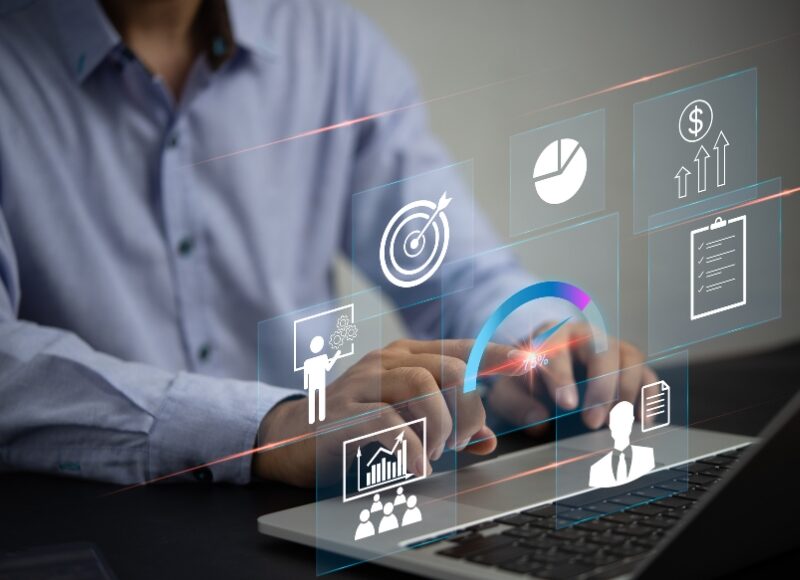 Google Ads metrics displayed on a laptop, including conversion rates, click-through rates, and performance analytics icons.