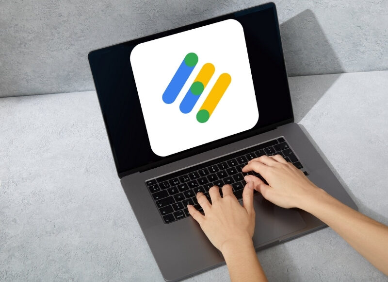 Person working on a computer, optimising Google Ads campaigns for maximum ROI.