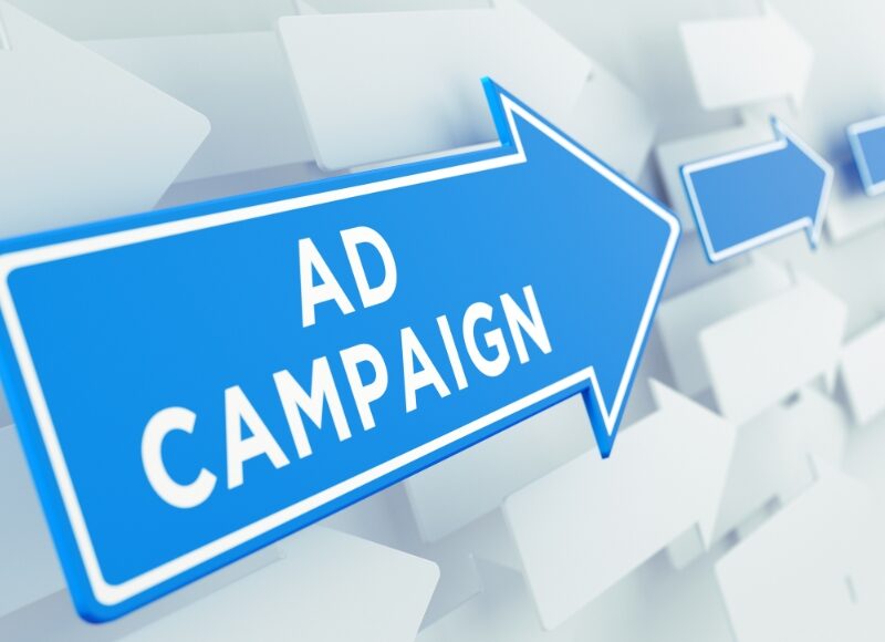 A blue directional arrow with "Ad Campaign" written on it, illustrating guidance in choosing a Google Ads campaign type.