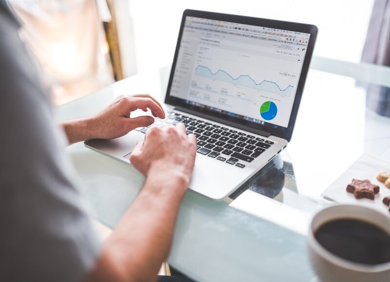 Person analysing a Google Ads performance report on a laptop.