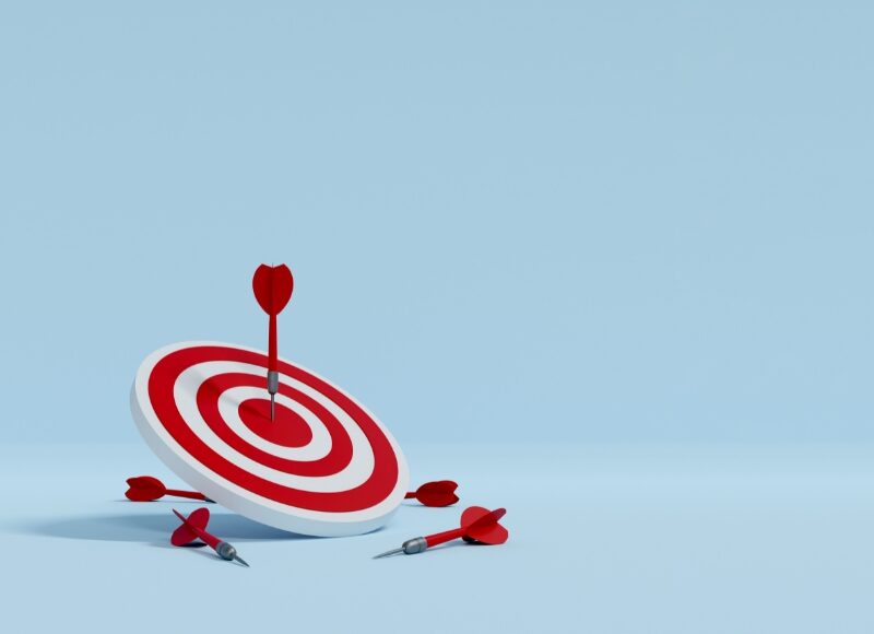 Google Ads seasonal promotion success—3D rendering of a red and white target with darts, symbolising campaign accuracy and conversion.