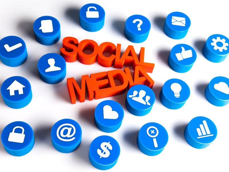 Social media marketing solutions concept with red text surrounded by blue digital icons.