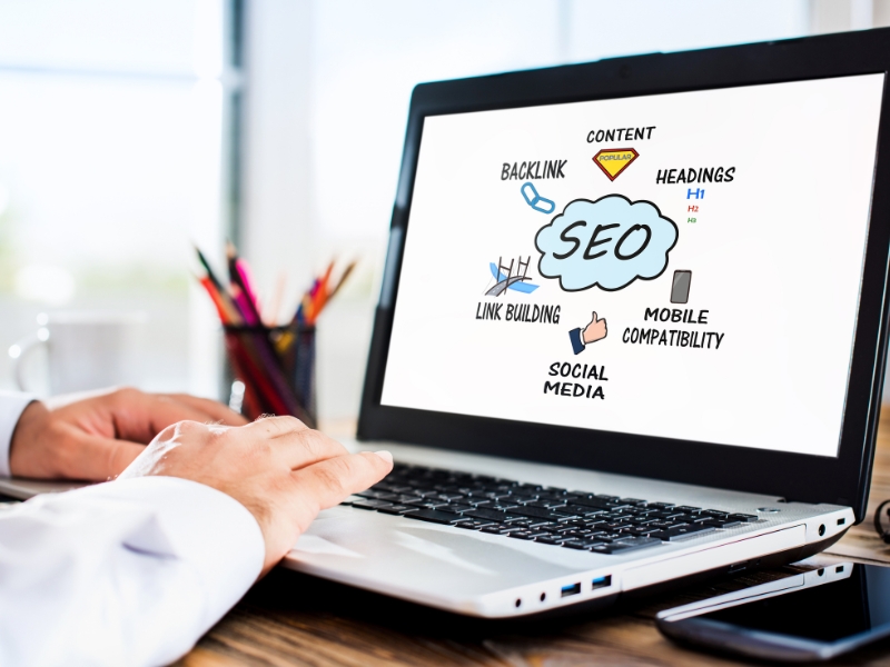Google Search Engine Consultants optimizing SEO strategy with laptop showing backlinks, content, and social media.