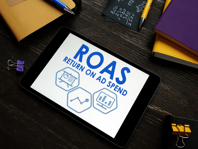Google Ads Management Agency improving ROAS return on ad spend with data insights on tablet.