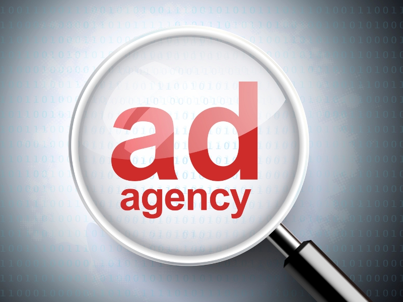 Magnifying glass showing ad agency concept linked to google ads agency for small business.