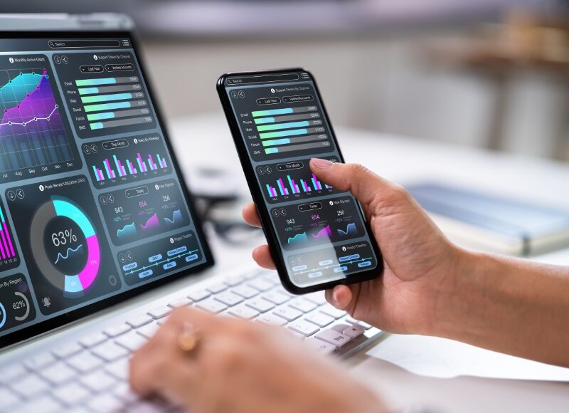 Marketing professional reviewing digital performance dashboards across devices using google ads management sydney tools.