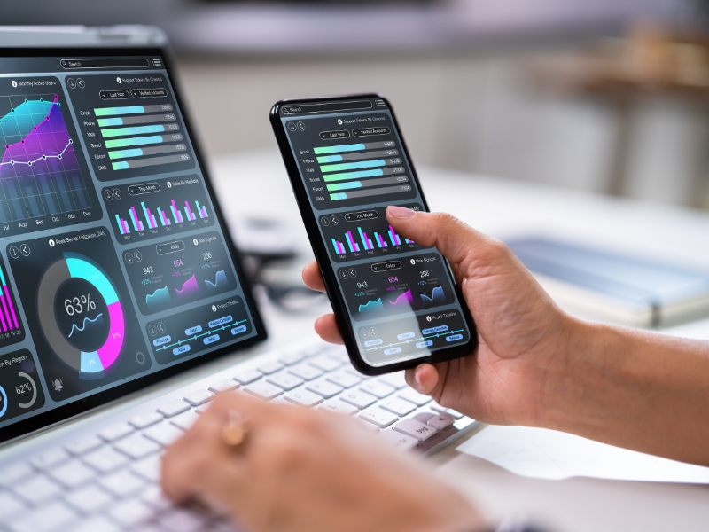 Marketing professional reviewing digital performance dashboards across devices using google ads management sydney tools.