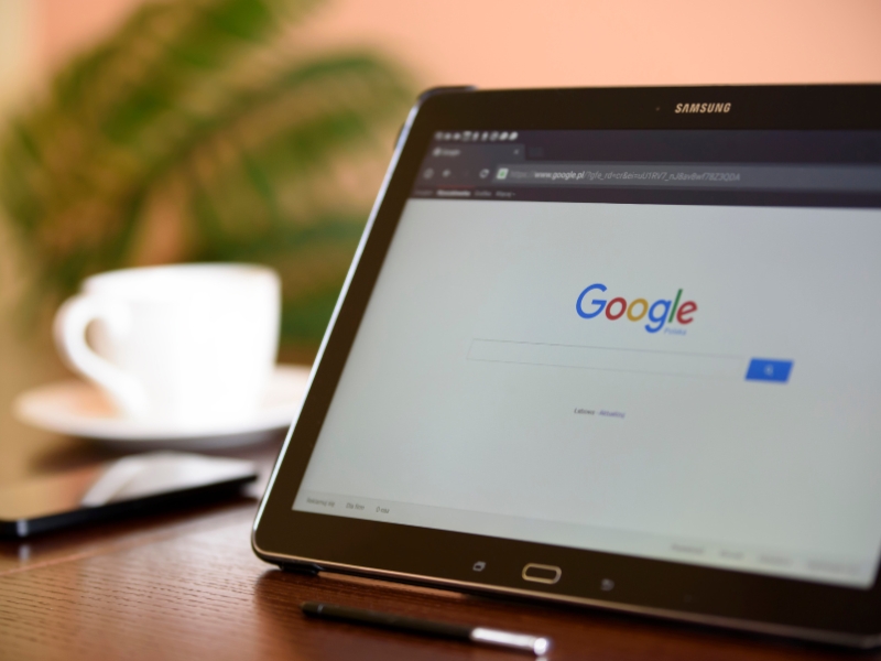 Google Ads Management Agency optimizing campaigns on Google search platform using tablet.