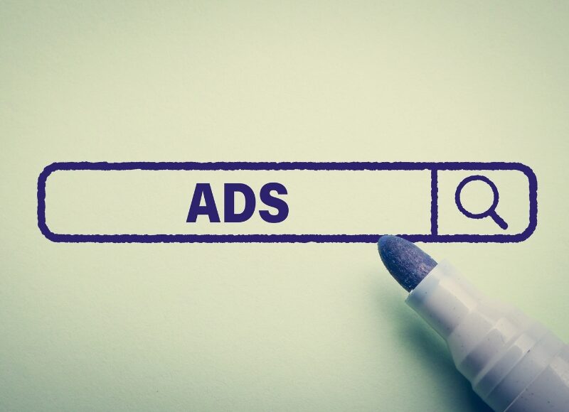 A search bar graphic with the word ADS and a marker tip, linked to guidance from Google Ads Experts.