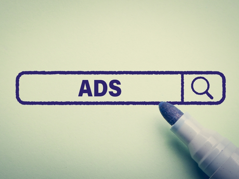 A search bar graphic with the word ADS and a marker tip, linked to guidance from Google Ads Experts.