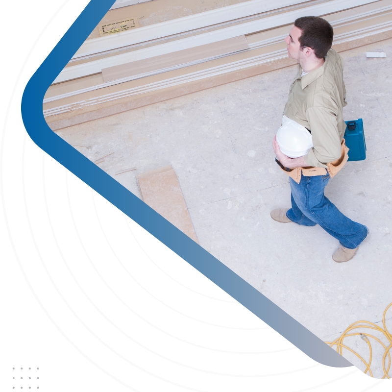 A man walks on a construction site with a blue and white triangle symbol, representing Auckland's home building industry and Facebook marketing.