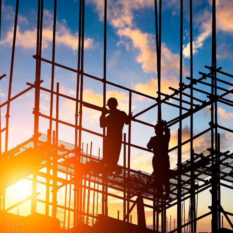 A construction site with workers silhouetted, highlighting effective digital marketing strategies for construction companies in the industry.