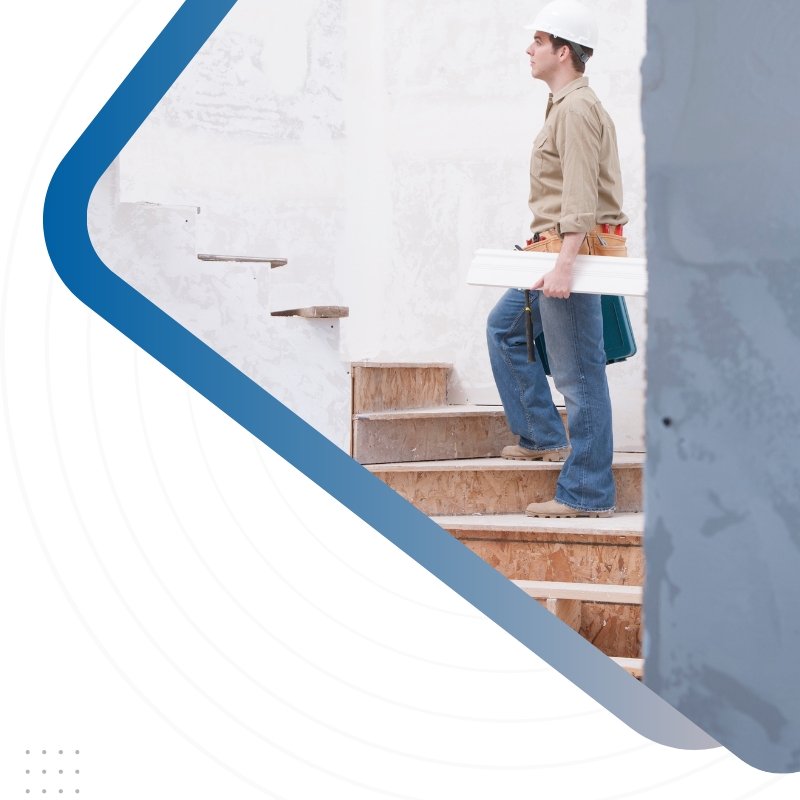 A man in a hard hat ascends stairs, set against a blue and white background, symbolising construction and home building.