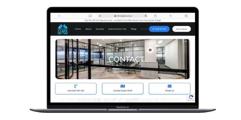 Laptop screen showing Intrinsic Glass contact page with call, location and email options
