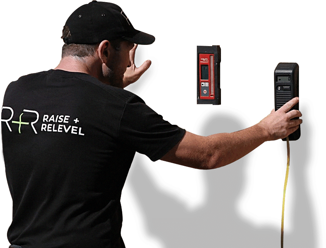 Raise and Relevel technician using survey equipment on site in branded uniform