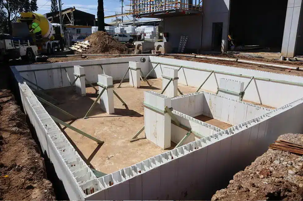 Permanent formwork wall system installed at a construction site foundation