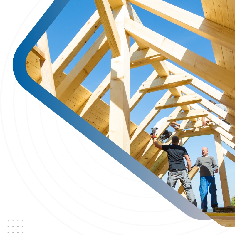 Two construction workers on a roof, using building materials, representing Website Design For Home Builders Auckland, New Zealand to showcase local craftsmanship.