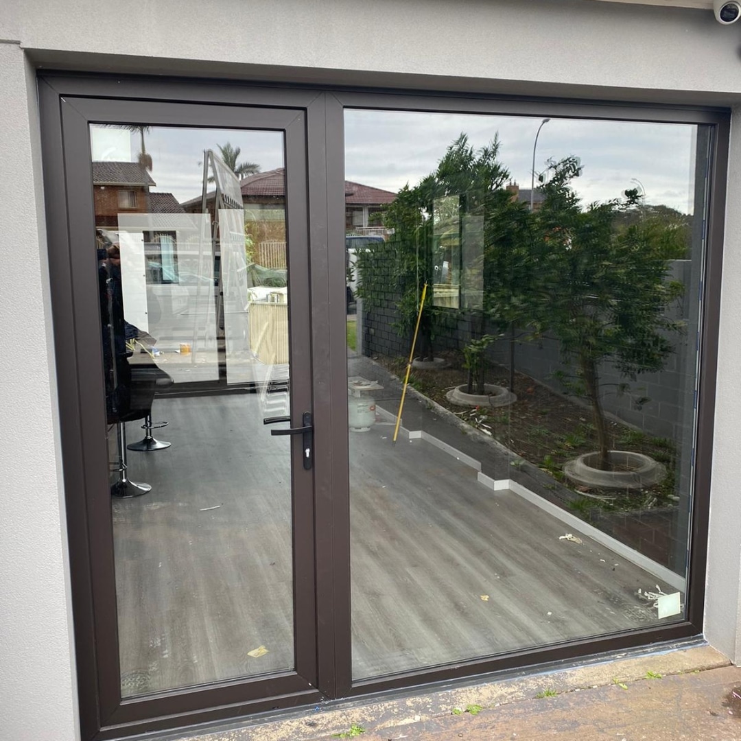 Large black framed uPVC window and door installation at a residential property