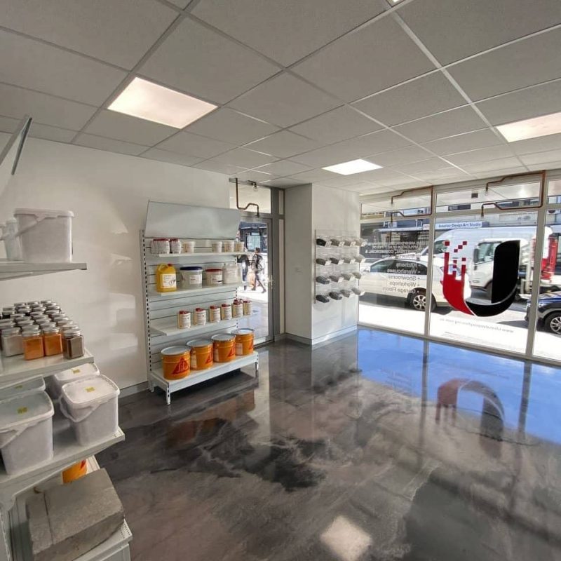 Epoxy flooring showroom interior with polished floor finish and product shelving